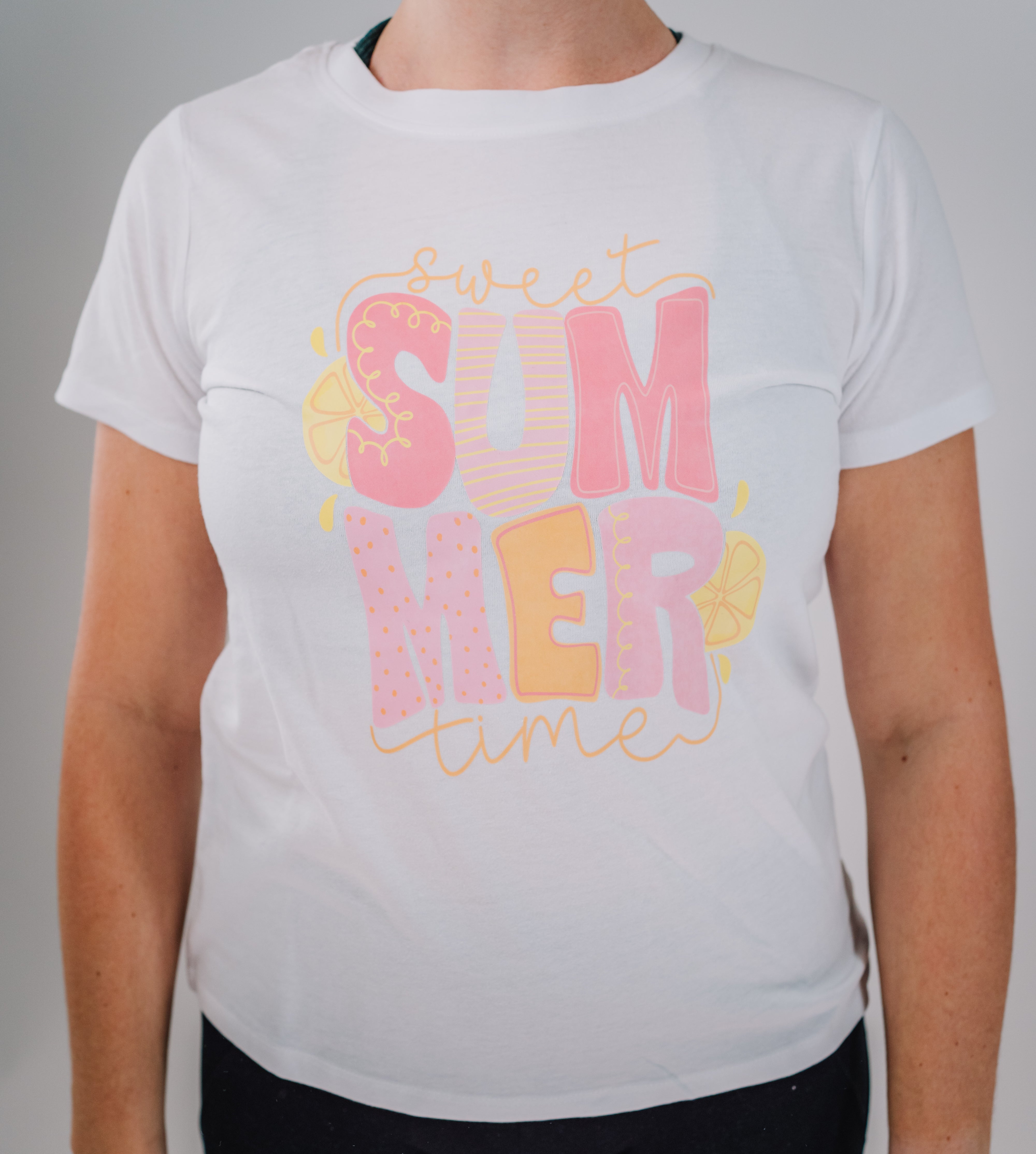 A woman wearing a white short-sleeved t-shirt with the text 'Summer Time' printed on the front.
