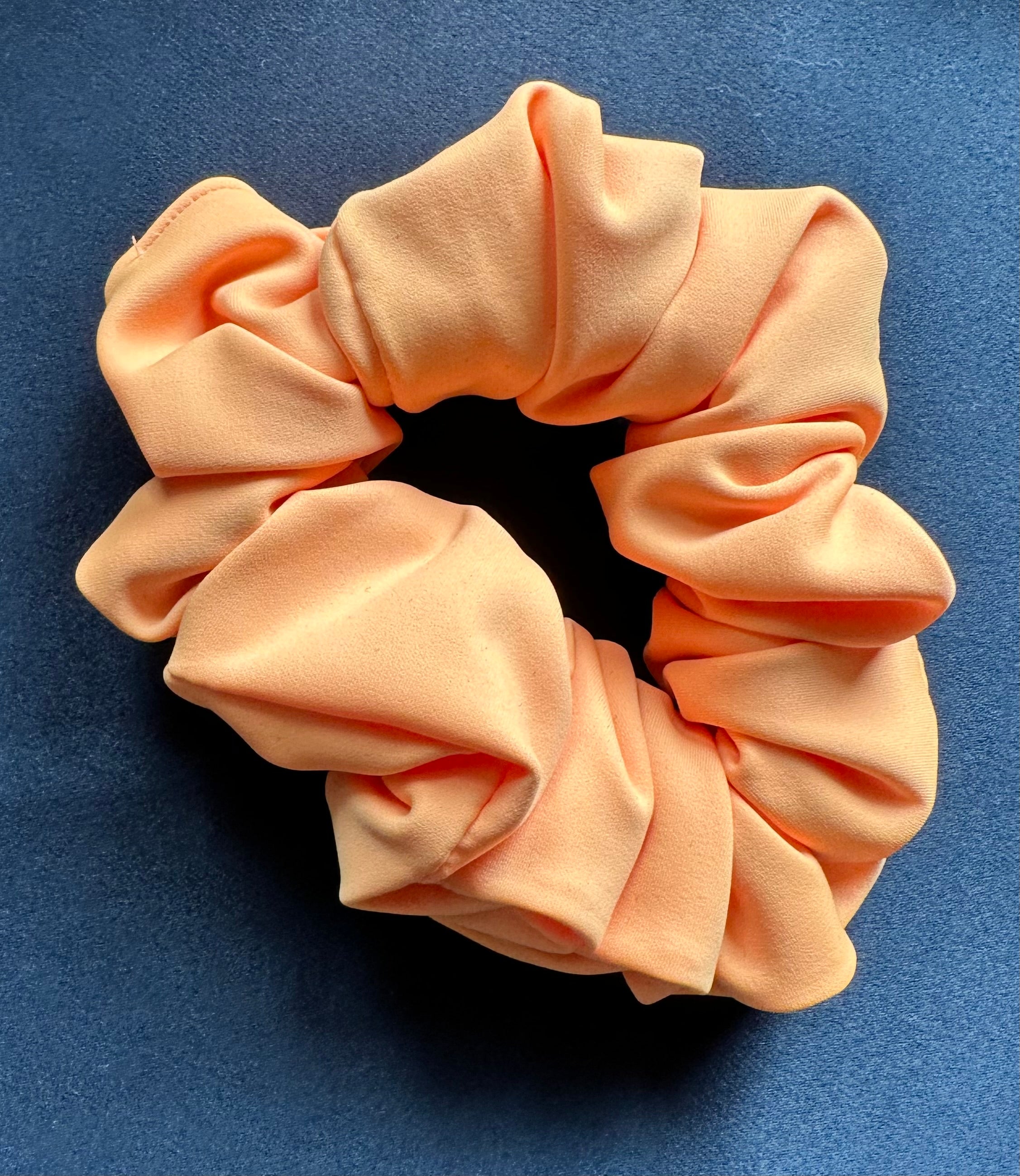 Pink scrunchie on a blue background