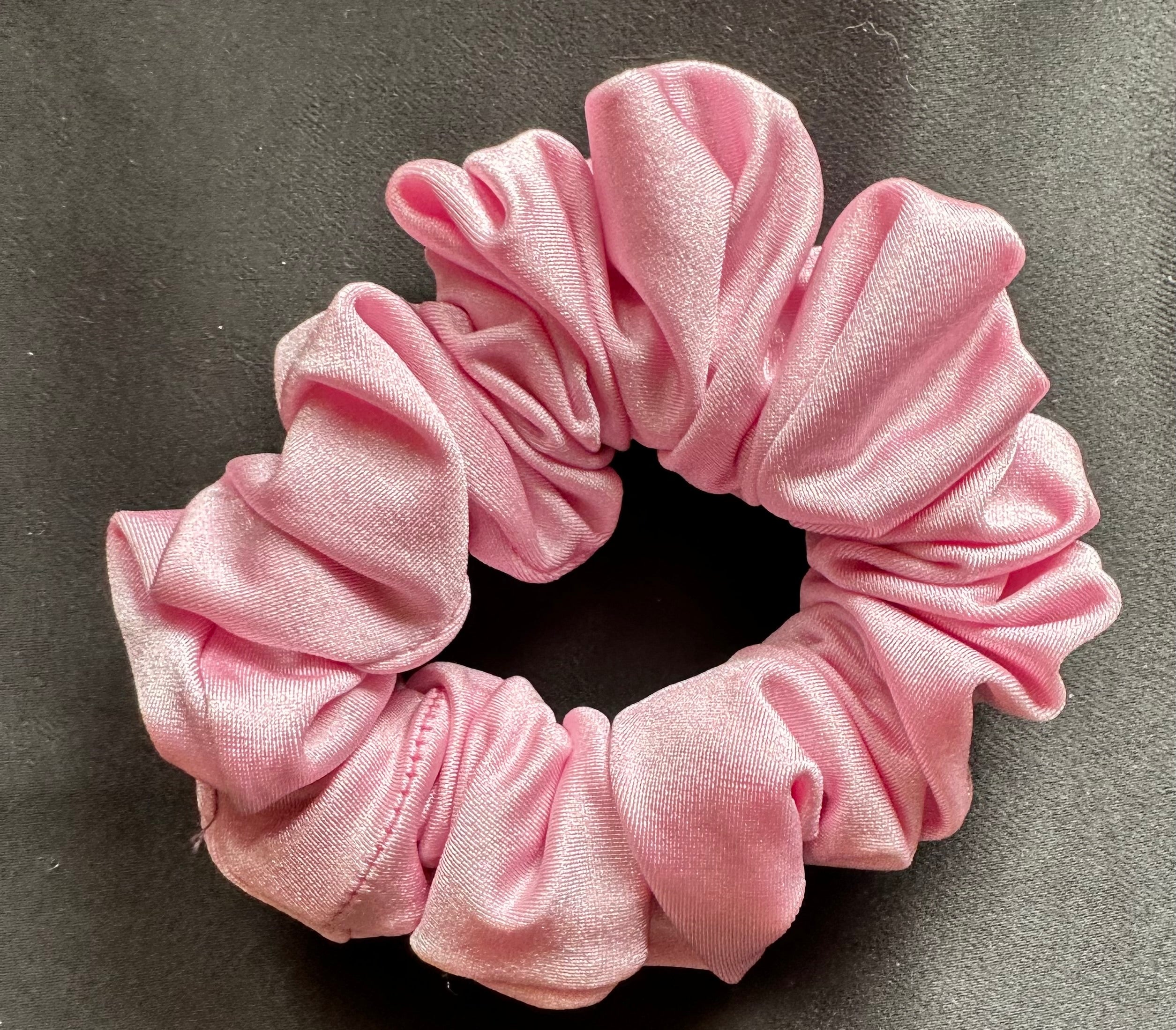 Pink scrunchie on a gray background