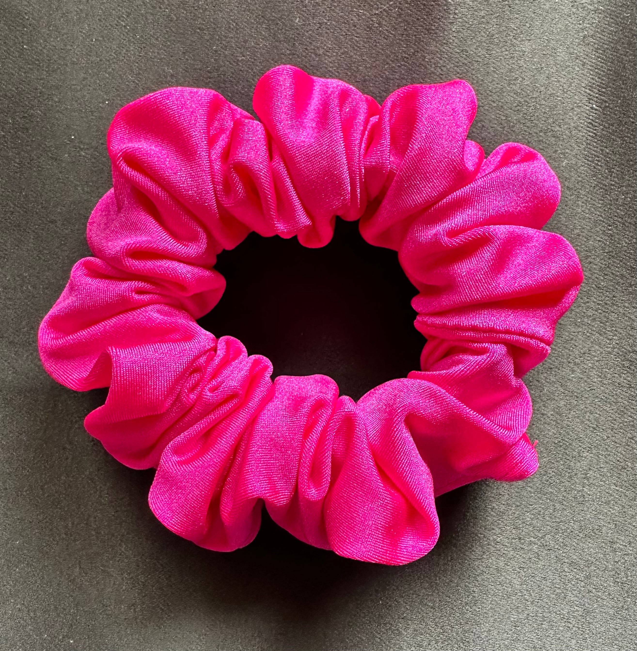 Pink scrunchie on a gray background