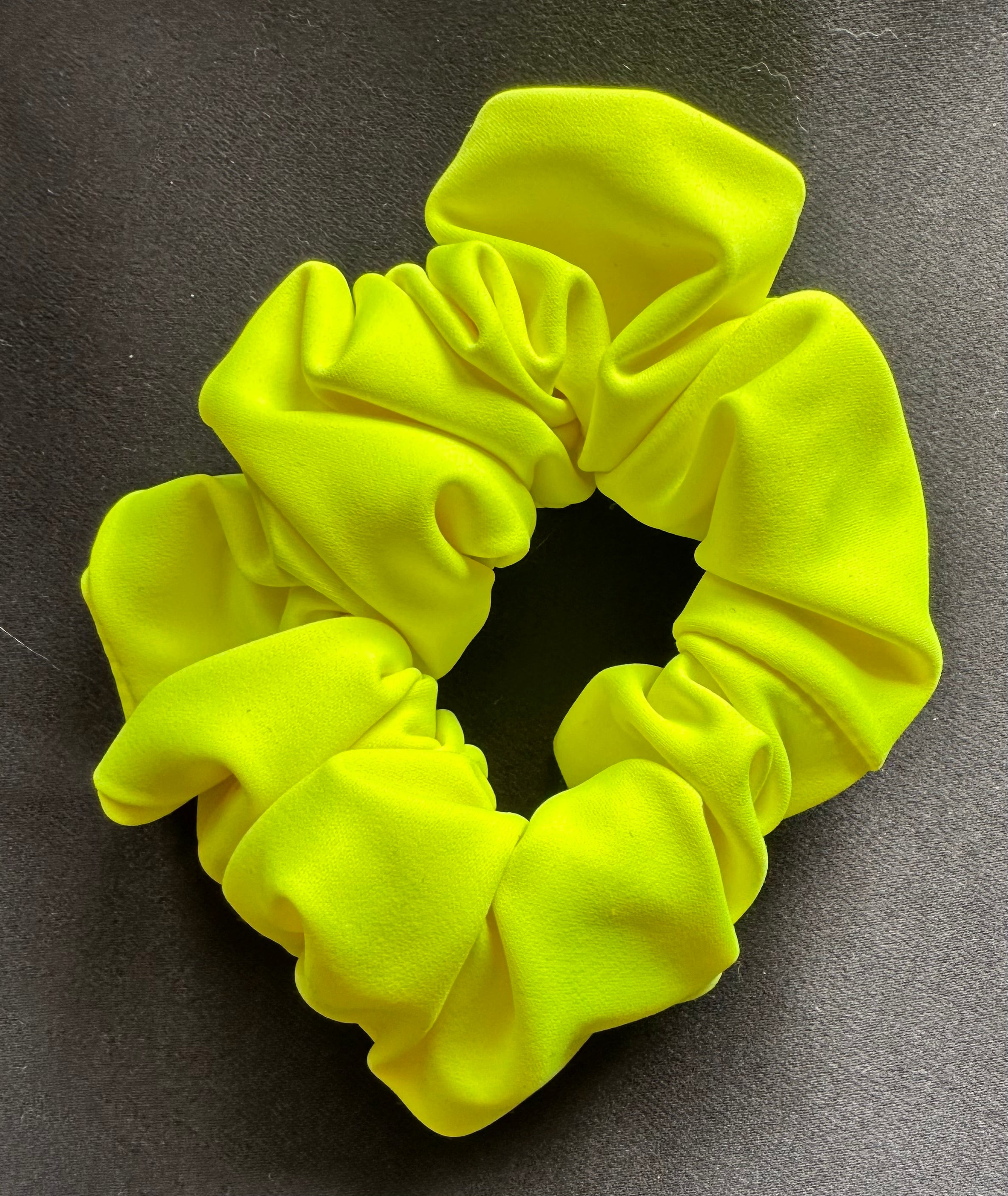 Yellow scrunchie on a gray background