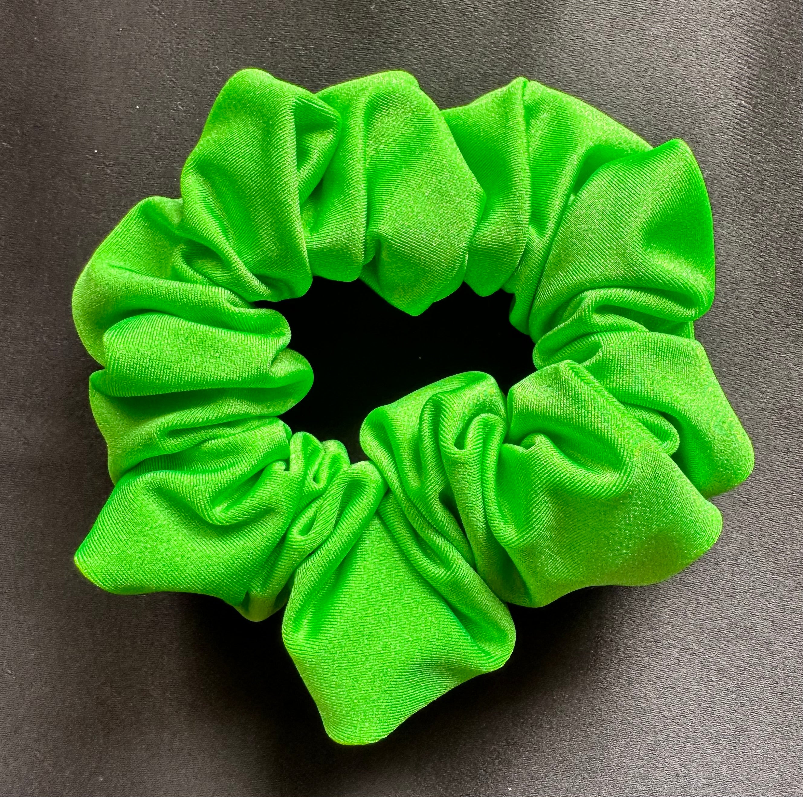 Green scrunchie on a gray background