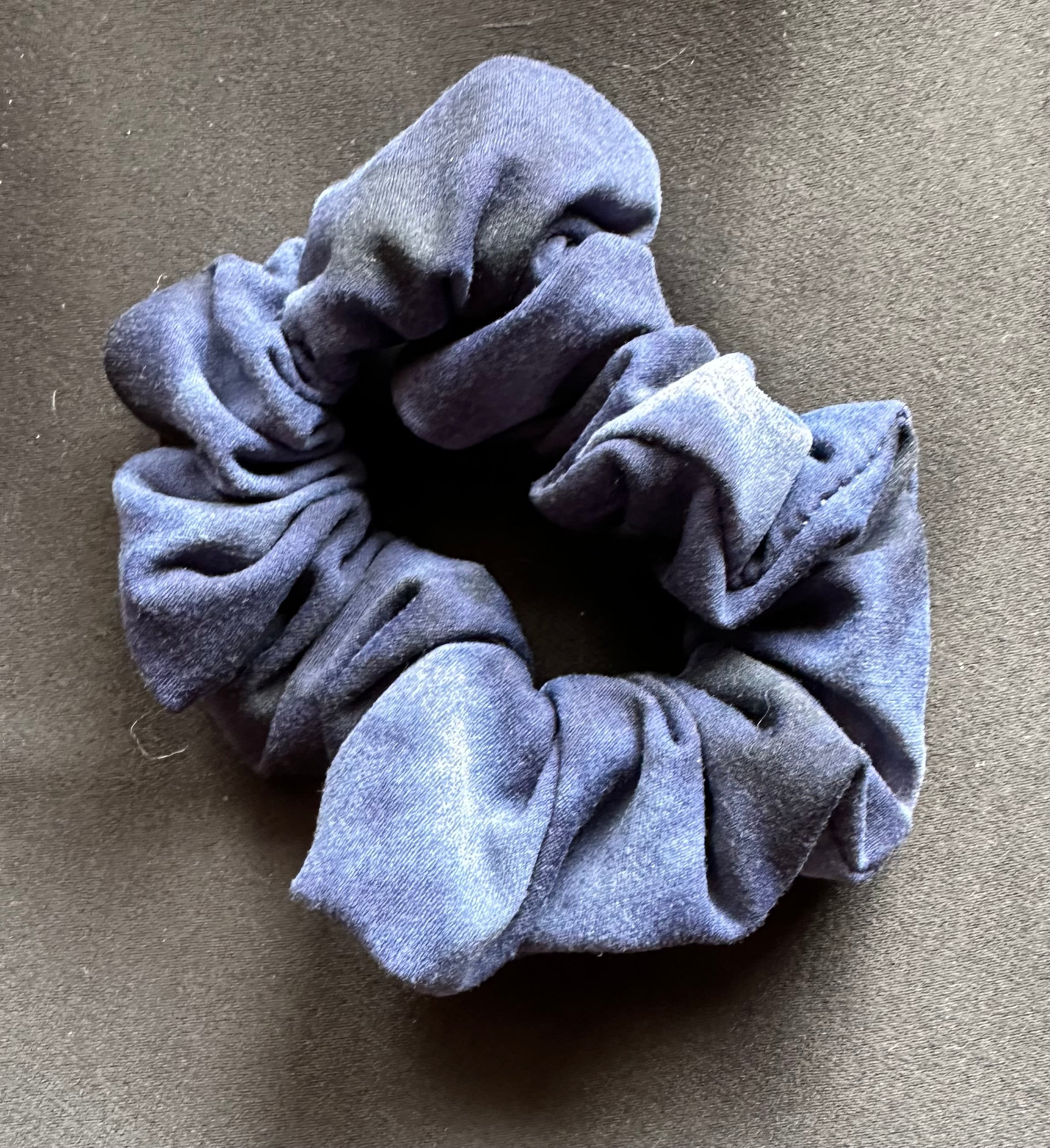 Blue scrunchie on a gray background