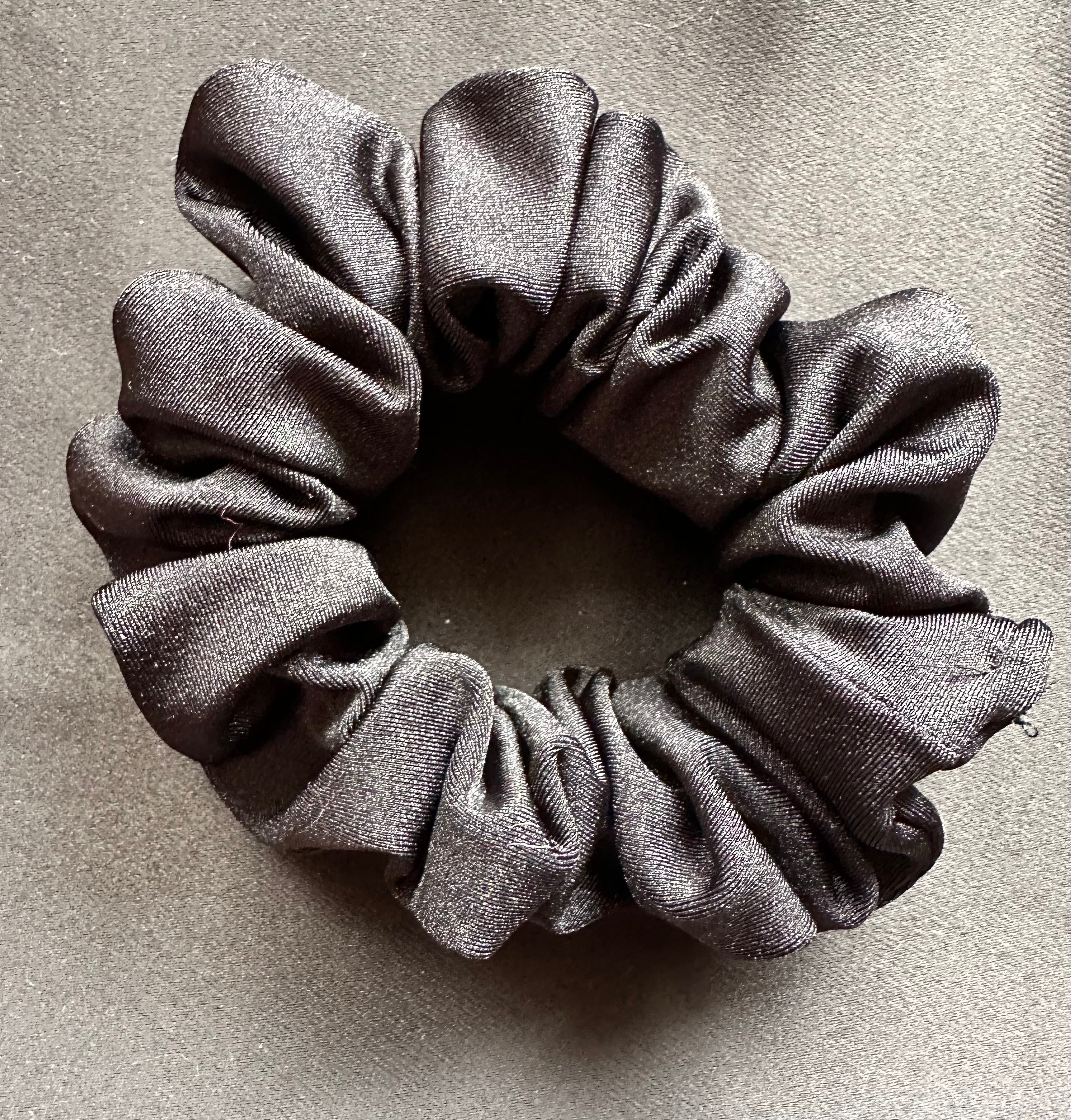 Gray scrunchie on a textured gray background