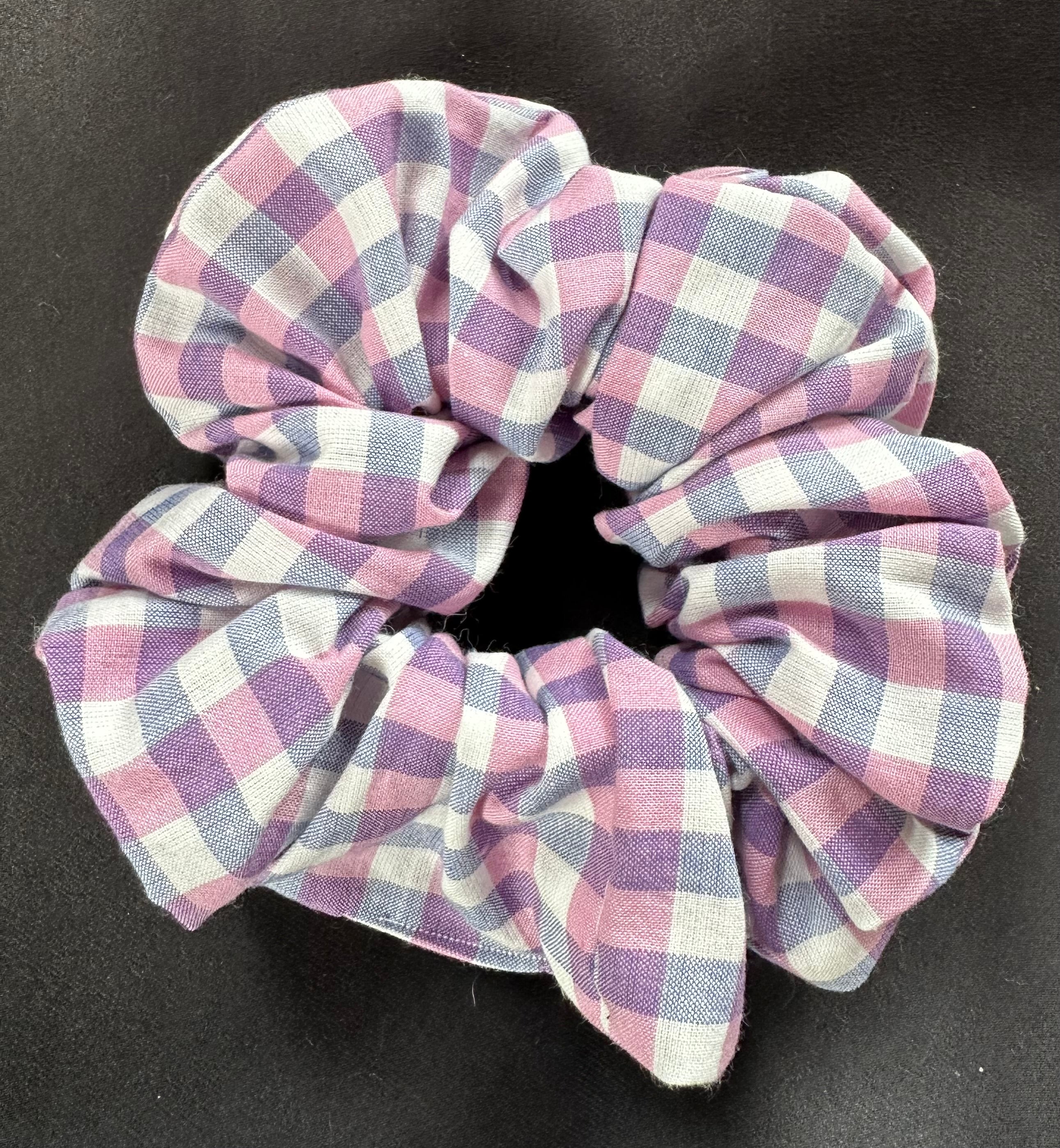 Plaid patterned scrunchie on a black background
